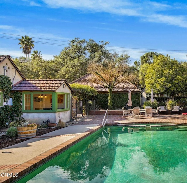 view of pool featuring a patio area and an outdoor structure