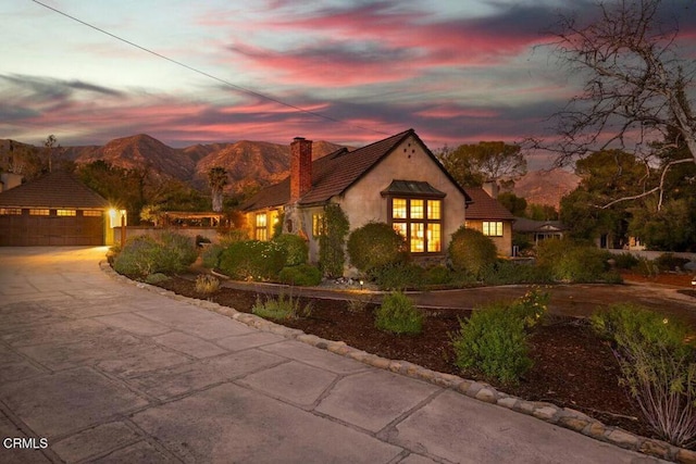 view of front of home with a garage and a mountain view