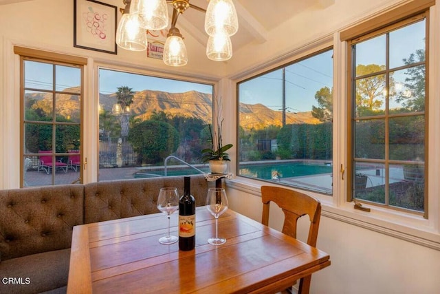 dining space with a wealth of natural light and a mountain view