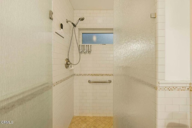 bathroom with a tile shower