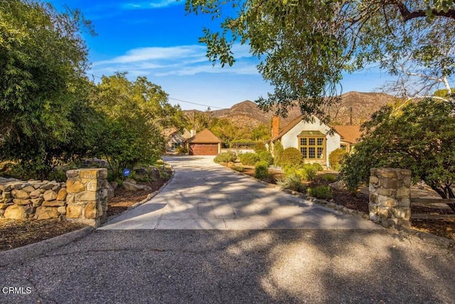 view of front of house featuring a garage and a mountain view