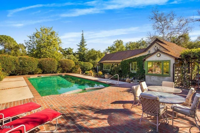 view of swimming pool with a patio and an outdoor structure