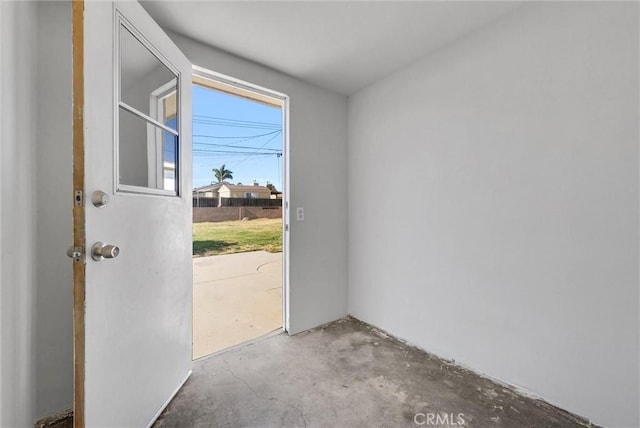 doorway to outside featuring concrete floors