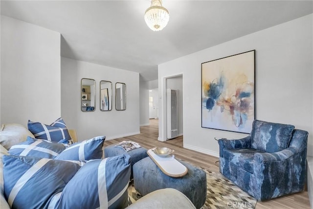 living room with wood-type flooring and a chandelier