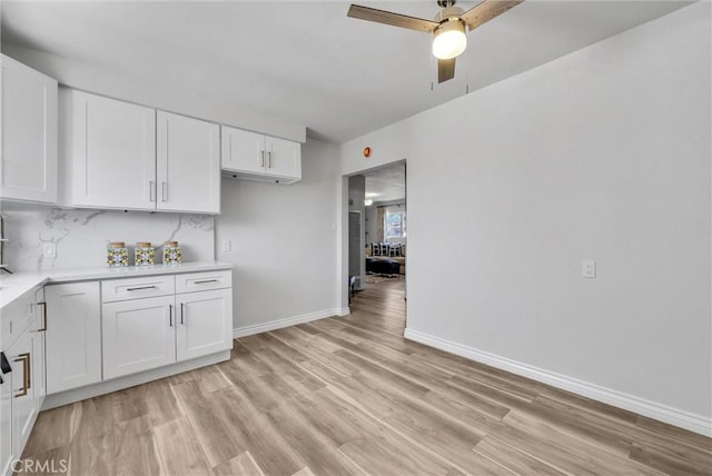 kitchen with white cabinets, ceiling fan, and decorative backsplash