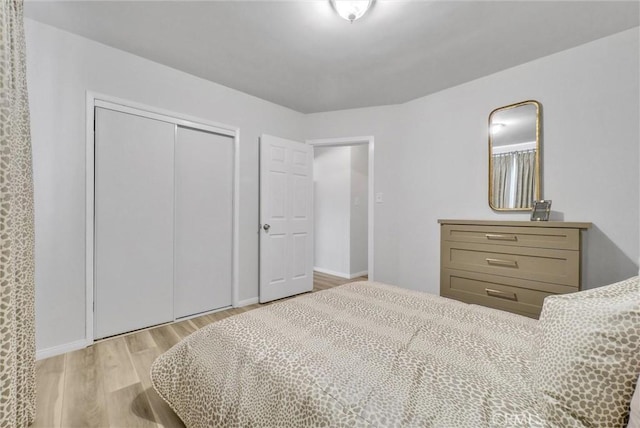 bedroom with a closet and light wood-type flooring