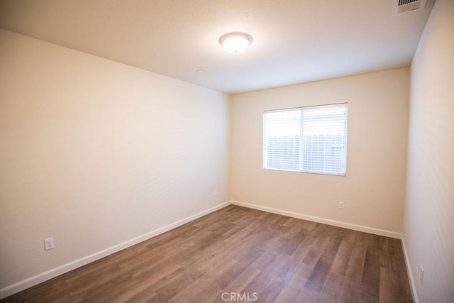 unfurnished room with wood-type flooring