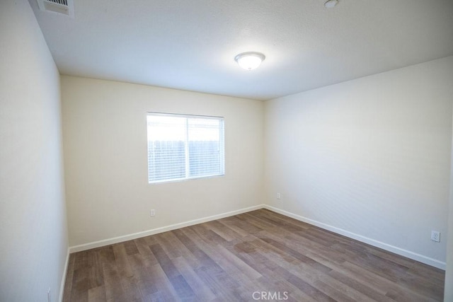 spare room with hardwood / wood-style flooring