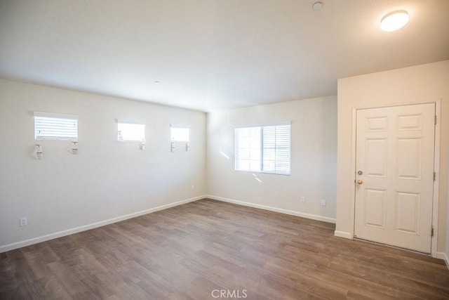 empty room with dark hardwood / wood-style floors