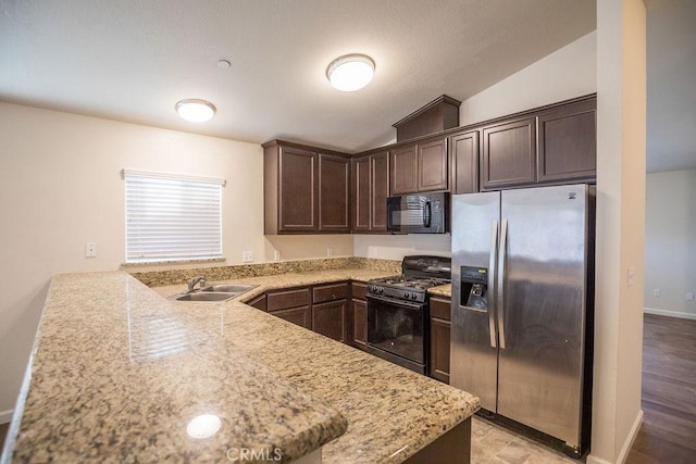 kitchen featuring sink, dark brown cabinets, kitchen peninsula, and black appliances