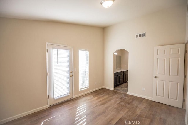 unfurnished room with hardwood / wood-style floors