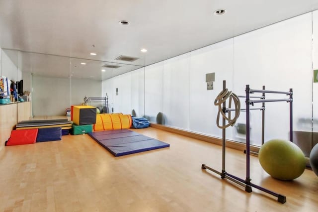 workout area with hardwood / wood-style floors