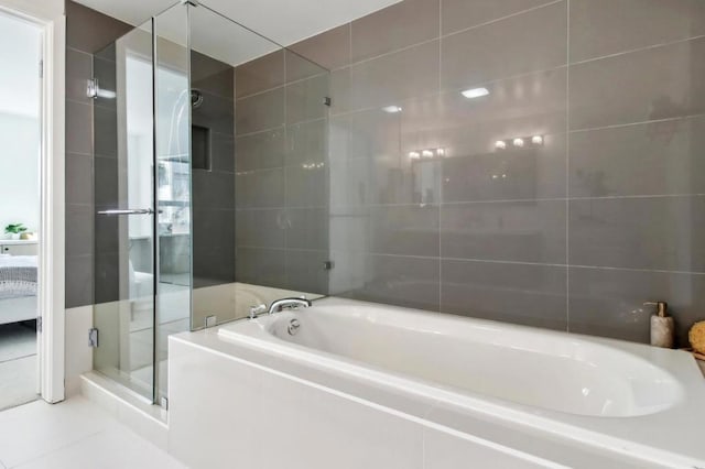 bathroom featuring tile patterned floors and shower with separate bathtub