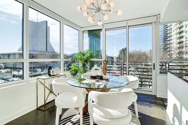 sunroom with plenty of natural light and a chandelier