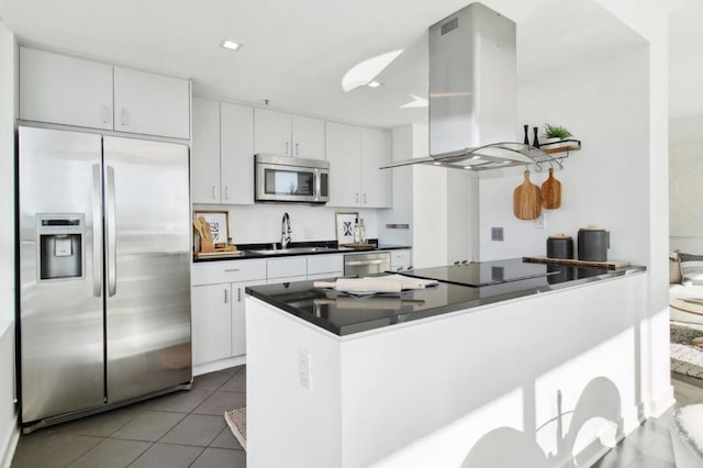 kitchen featuring sink, island range hood, stainless steel appliances, and white cabinetry