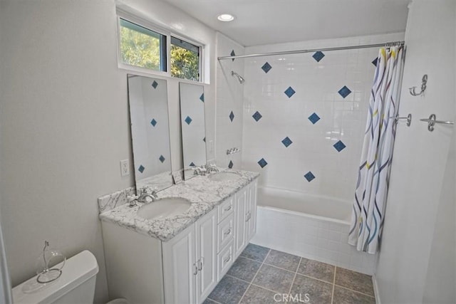 full bathroom with shower / tub combo with curtain, vanity, tile patterned floors, and toilet