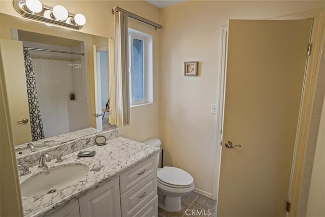 bathroom featuring vanity, curtained shower, tile patterned floors, and toilet