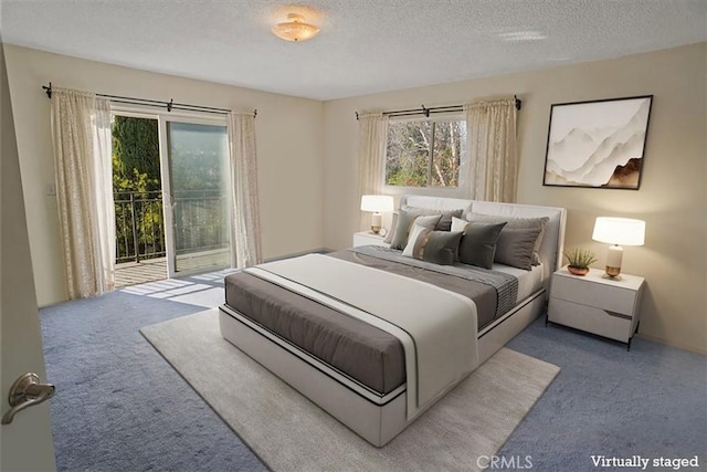 carpeted bedroom featuring access to outside and a textured ceiling