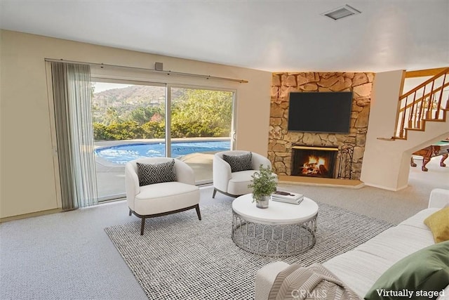 living room with a stone fireplace