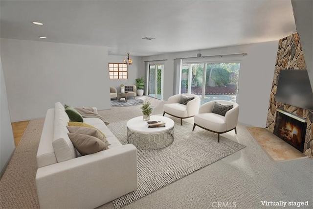 living room featuring a notable chandelier and a fireplace