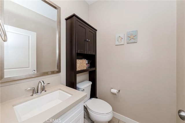 bathroom featuring toilet and vanity