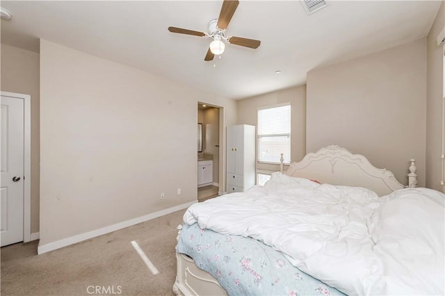 carpeted bedroom with ceiling fan and ensuite bathroom