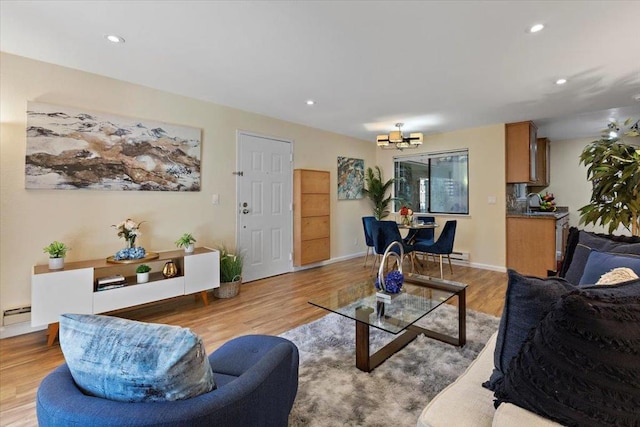 living room featuring a chandelier and light hardwood / wood-style floors