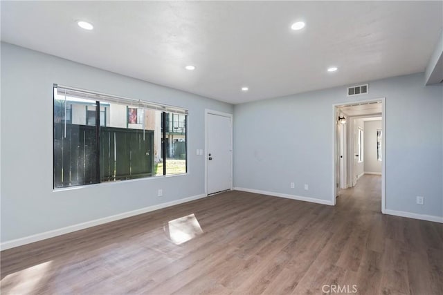 spare room with hardwood / wood-style floors