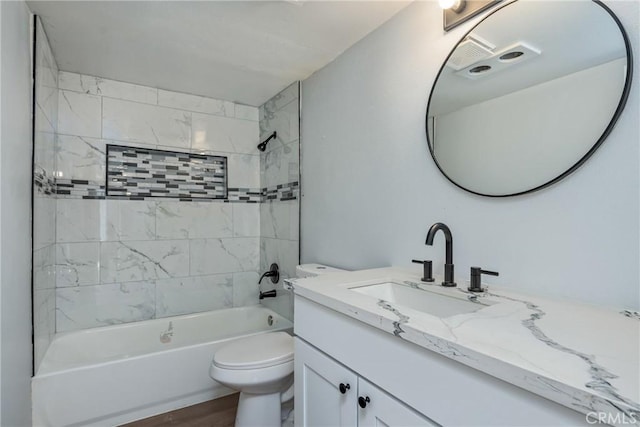 full bathroom with toilet, vanity, hardwood / wood-style flooring, and tiled shower / bath