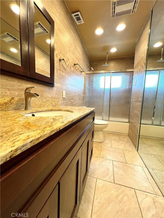 full bathroom with visible vents, a combined bath / shower with rainfall shower, and tile walls