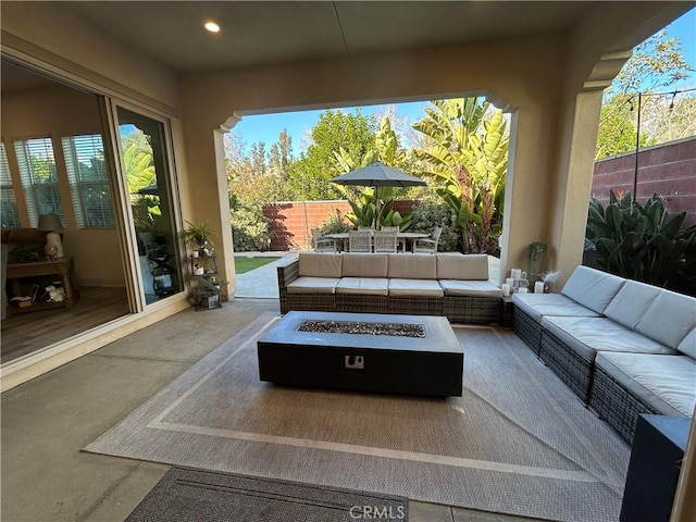 view of patio / terrace featuring an outdoor living space with a fire pit