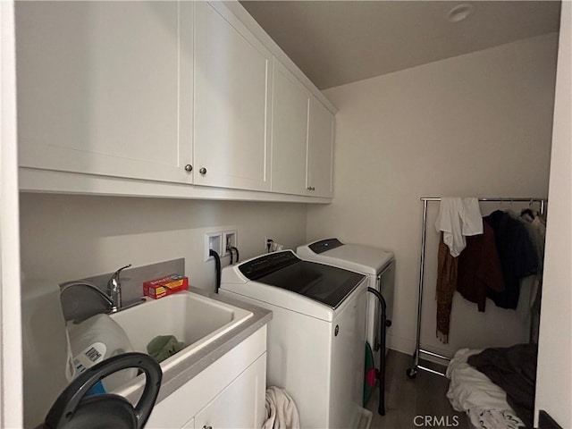 clothes washing area featuring cabinets, separate washer and dryer, dark hardwood / wood-style flooring, and sink