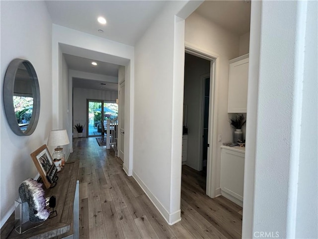 corridor with light hardwood / wood-style flooring