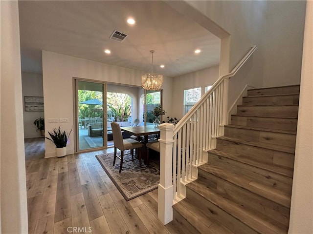 dining room with light hardwood / wood-style floors and a chandelier