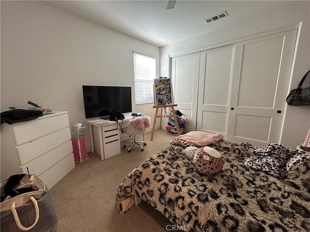 carpeted bedroom featuring a closet and ceiling fan