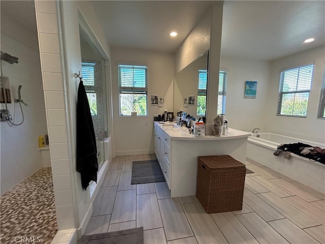 bathroom featuring plus walk in shower and vanity