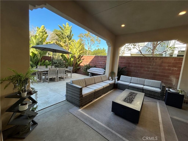 view of patio / terrace featuring an outdoor living space with a fire pit