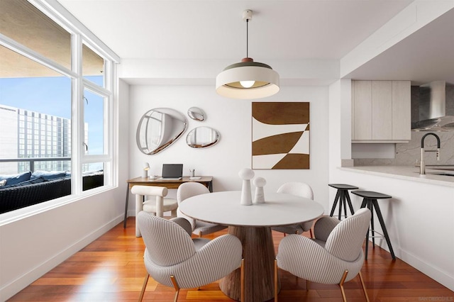 dining space featuring sink and light wood-type flooring