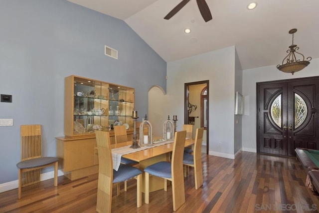 dining space with ceiling fan, dark wood-type flooring, and vaulted ceiling