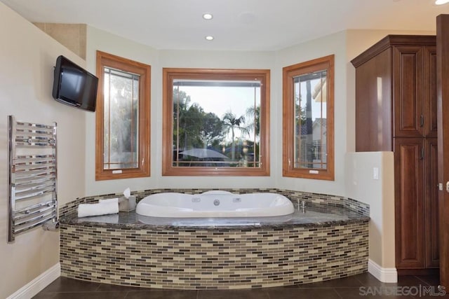 bathroom featuring radiator heating unit, a healthy amount of sunlight, and tile patterned flooring