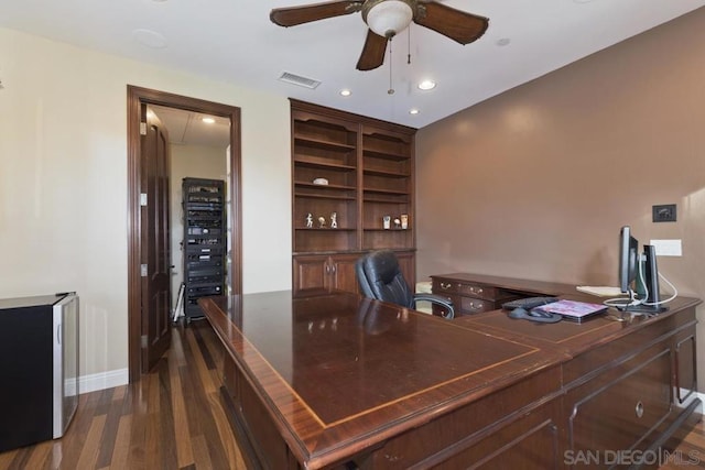 office area with ceiling fan, dark wood-type flooring, and built in features