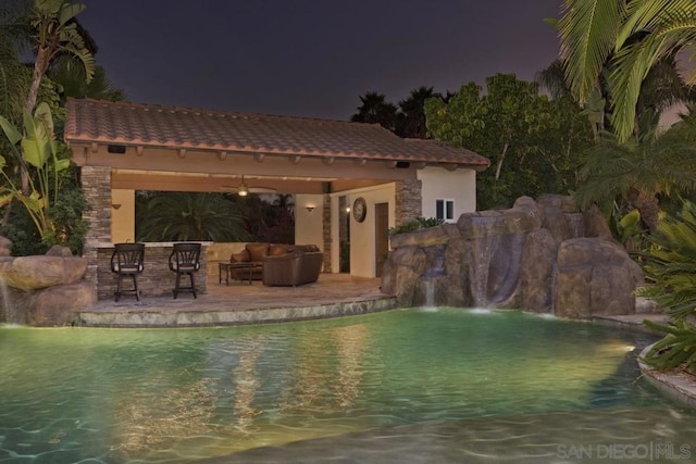 view of swimming pool with an outdoor hangout area, a patio area, a gazebo, and pool water feature