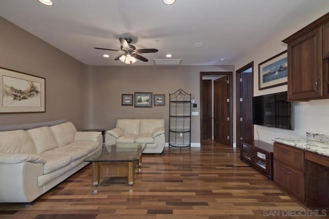 living room with ceiling fan and dark hardwood / wood-style flooring