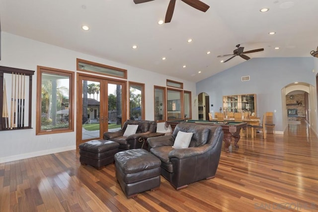 living room with hardwood / wood-style flooring, french doors, ceiling fan, and lofted ceiling