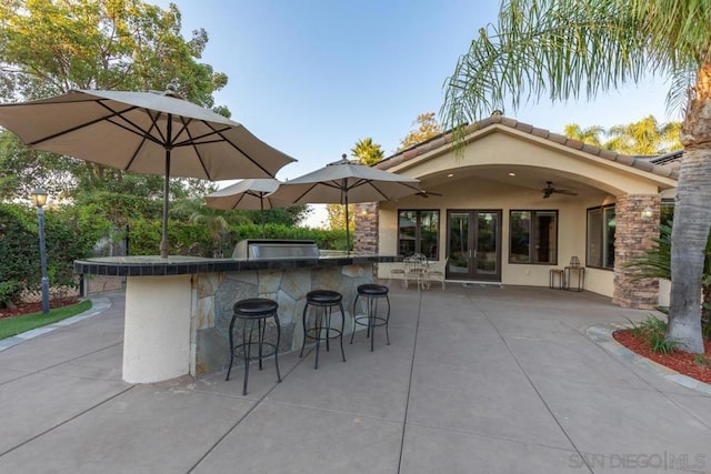 view of patio featuring ceiling fan and french doors