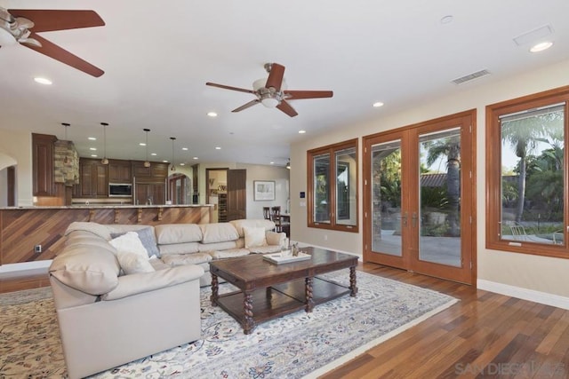 living room with ceiling fan, french doors, and dark wood-type flooring