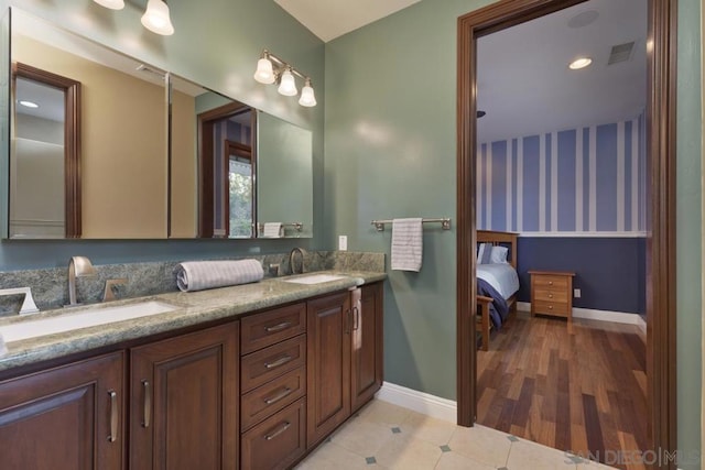 bathroom featuring tile patterned flooring and vanity