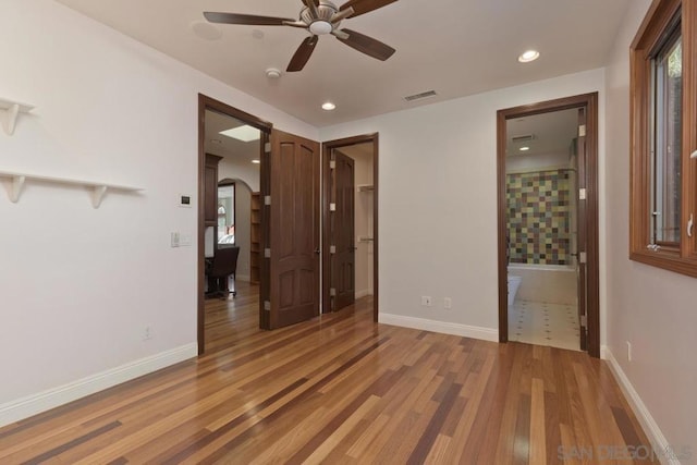 unfurnished room featuring ceiling fan and hardwood / wood-style floors