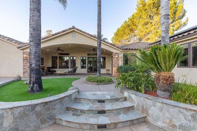 rear view of property featuring a patio and ceiling fan