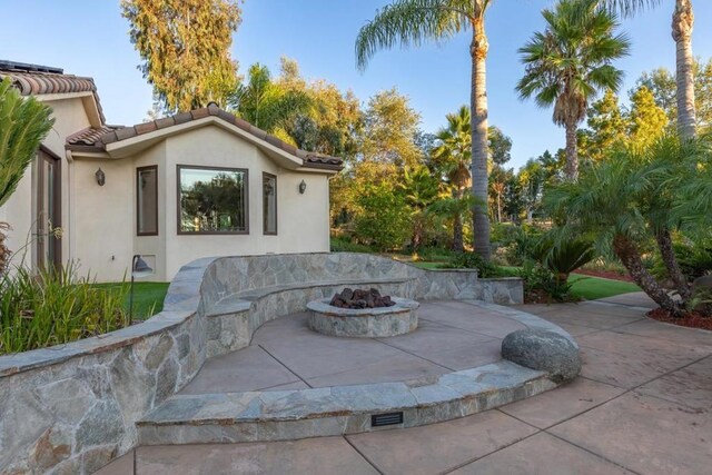 view of patio / terrace featuring a fire pit